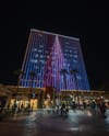A photo of a nighttime light display of Downtown Riverside building.