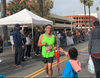 A photo of a 2021 Mission Inn Run participant passing the finish line.