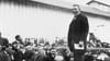 Black and white photo of Dr. Booker T. Washington delivering a speech.